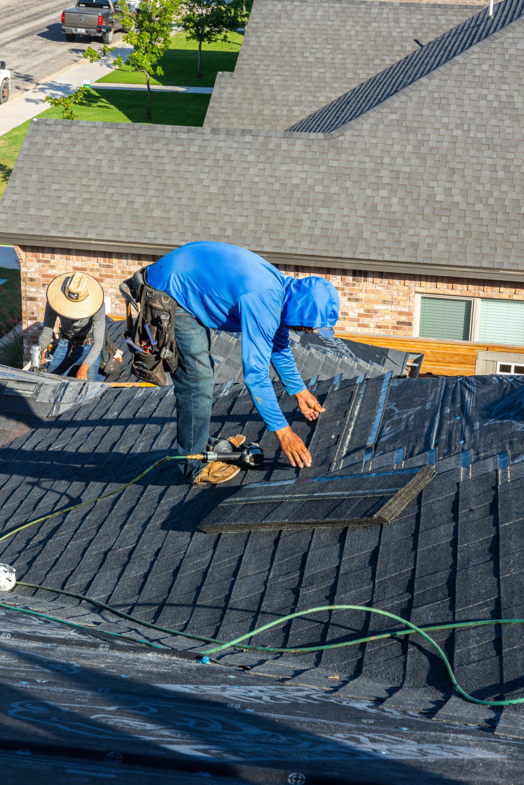 man in a blue jacket fixing a roof